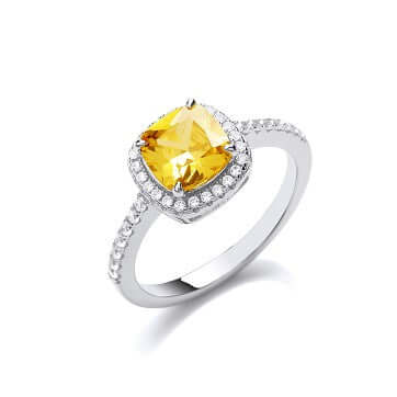 Silver Yellow Solitaire ring with yellow cushion cut cubic zirconia and brilliant stones forming a halo and shoulder accents.
