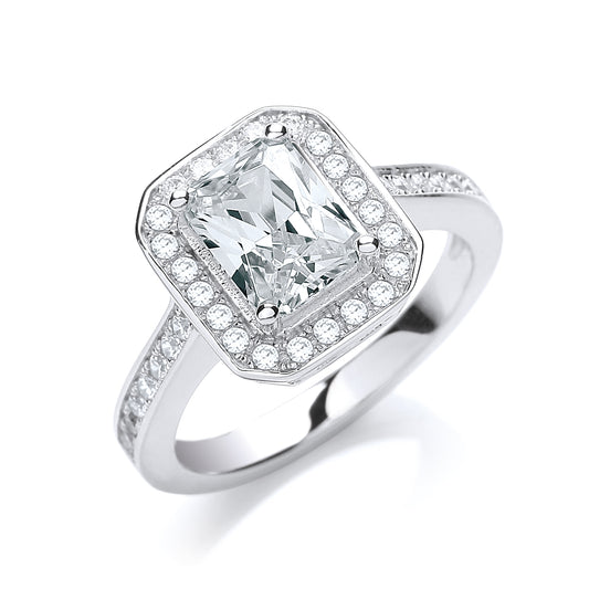 Silver ring with a large central diamond and smaller diamonds around on a white background